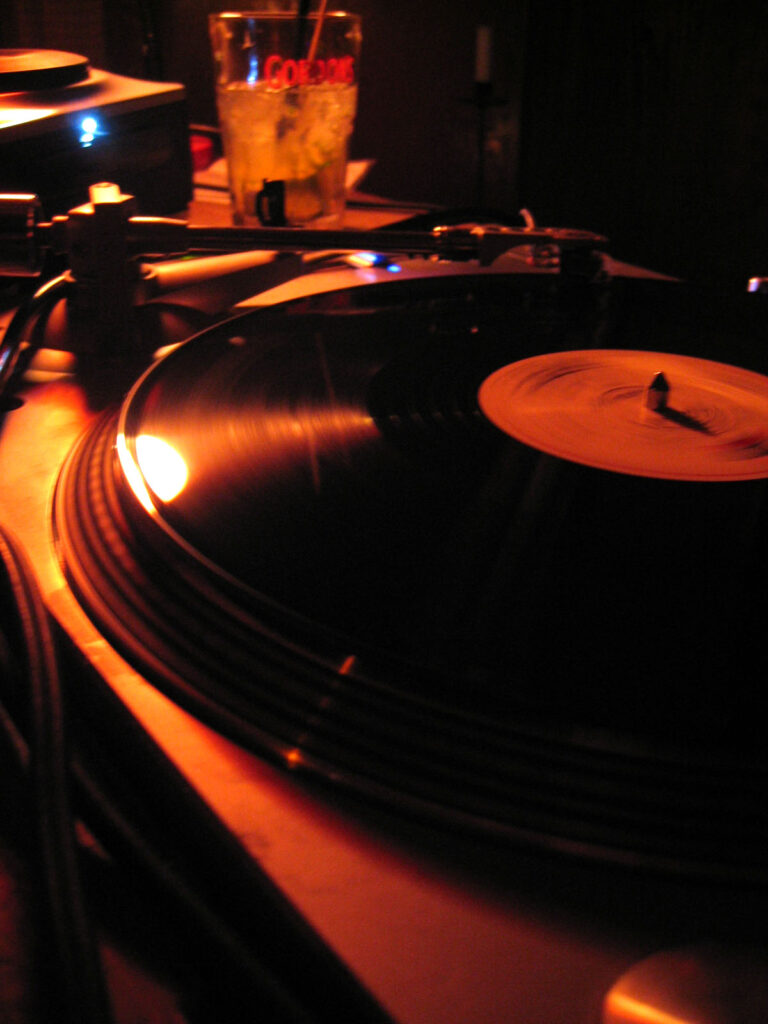 DJ Gino Tonico performing with turntables in the 2000s