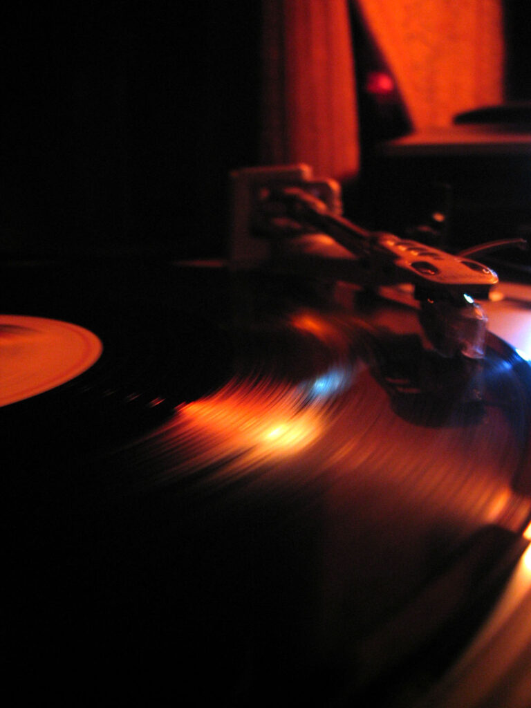 DJ Gino Tonico performing with turntables in the 2000s