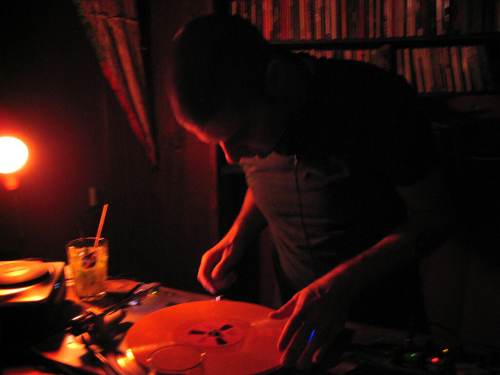 DJ Gino Tonico performing with turntables in the 2000s